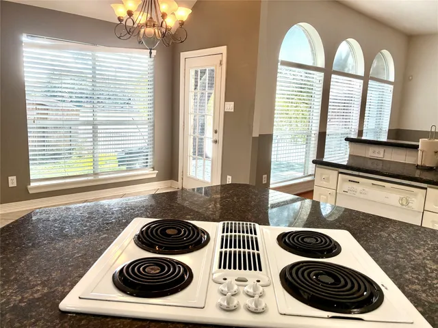 a stove top oven sitting inside of a kitchen
