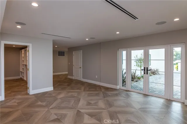 a kitchen with a white wooden cabinets and window