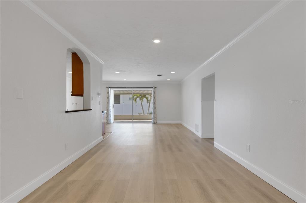 3856 Tarpon Road Venice, FL 34293 - Photo 13 of 53 a view of an empty room with wooden floor and a window