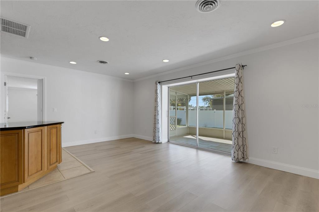 3856 Tarpon Road Venice, FL 34293 - Photo 14 of 53 an empty room with sliding door and wooden floor