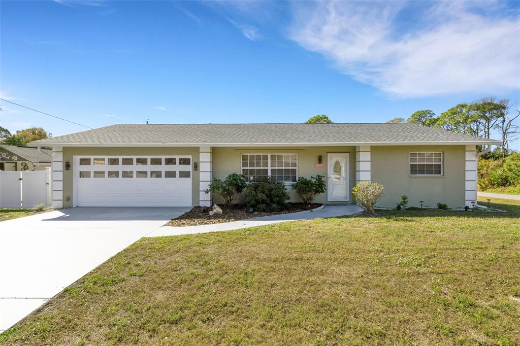 3856 Tarpon Road Venice, FL 34293 - Photo 2 of 53 a front view of a house with a yard