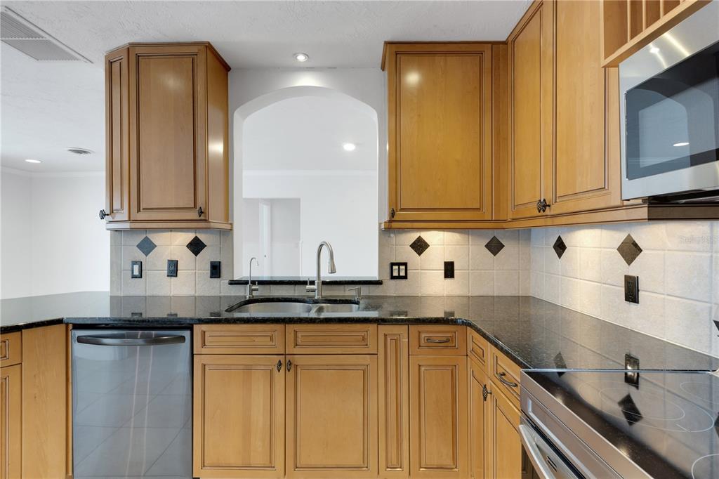 3856 Tarpon Road Venice, FL 34293 - Photo 22 of 53 a kitchen with stainless steel appliances granite countertop a sink and cabinets