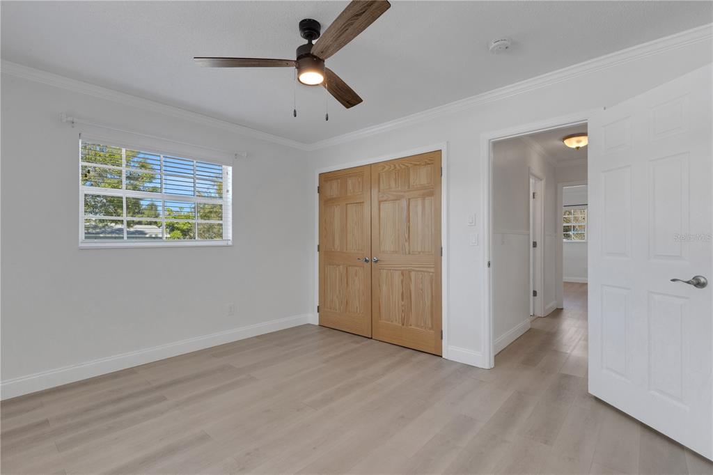 3856 Tarpon Road Venice, FL 34293 - Photo 26 of 53 an empty room with ceiling fan and windows
