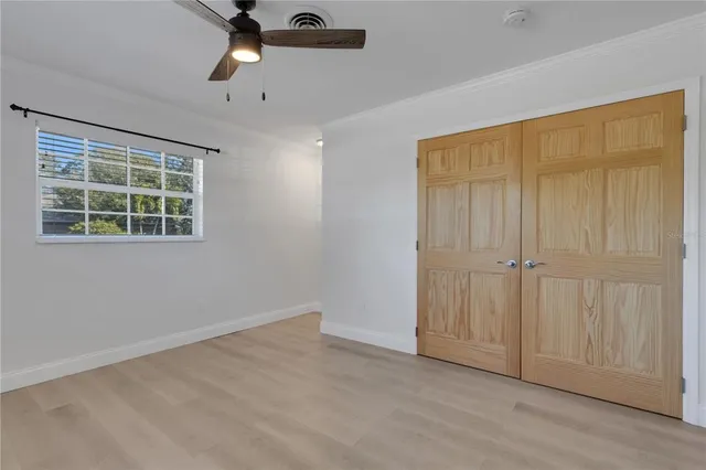 an empty room with windows and closet