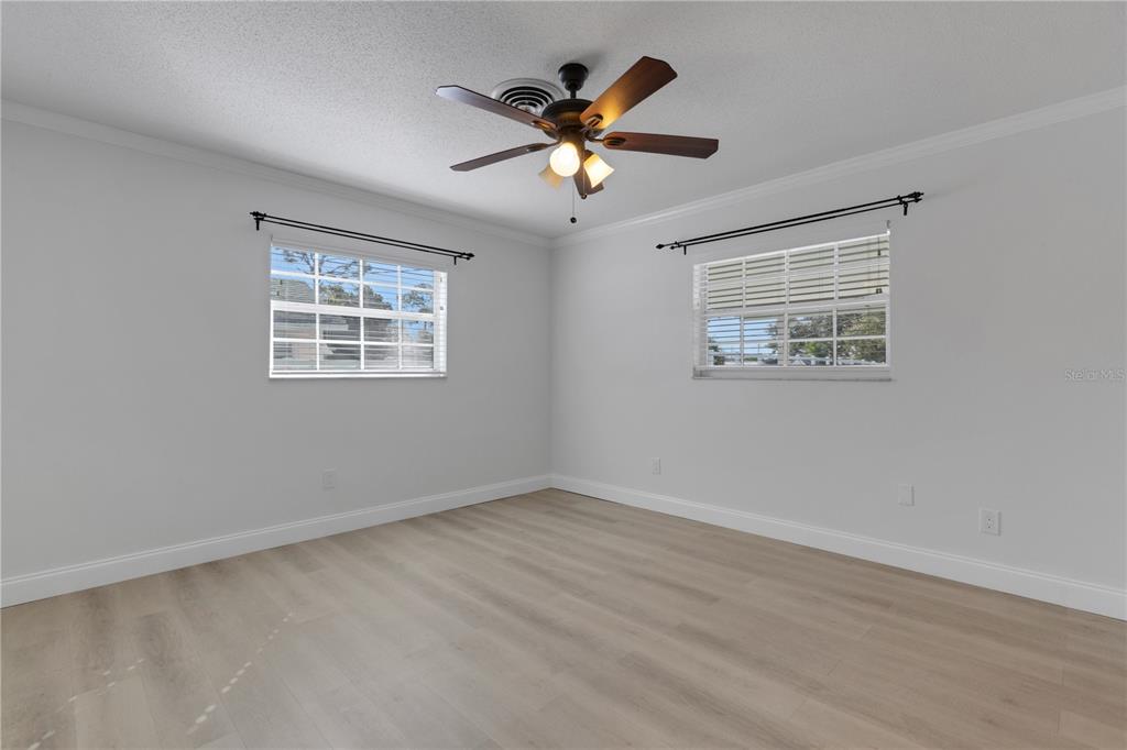 3856 Tarpon Road Venice, FL 34293 - Photo 33 of 53 a view of an empty room with a ceiling fan and a window