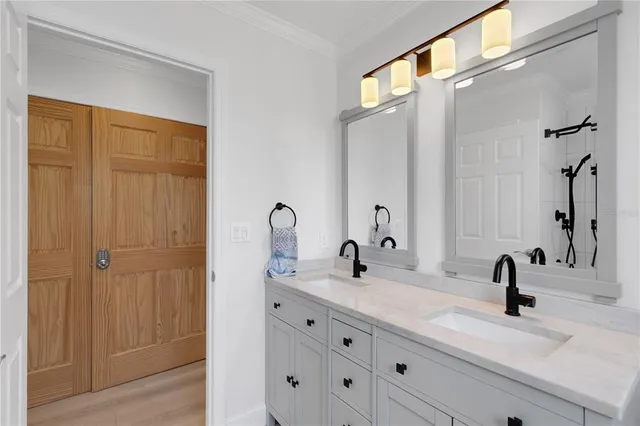 a bathroom with a double vanity sink and a mirror