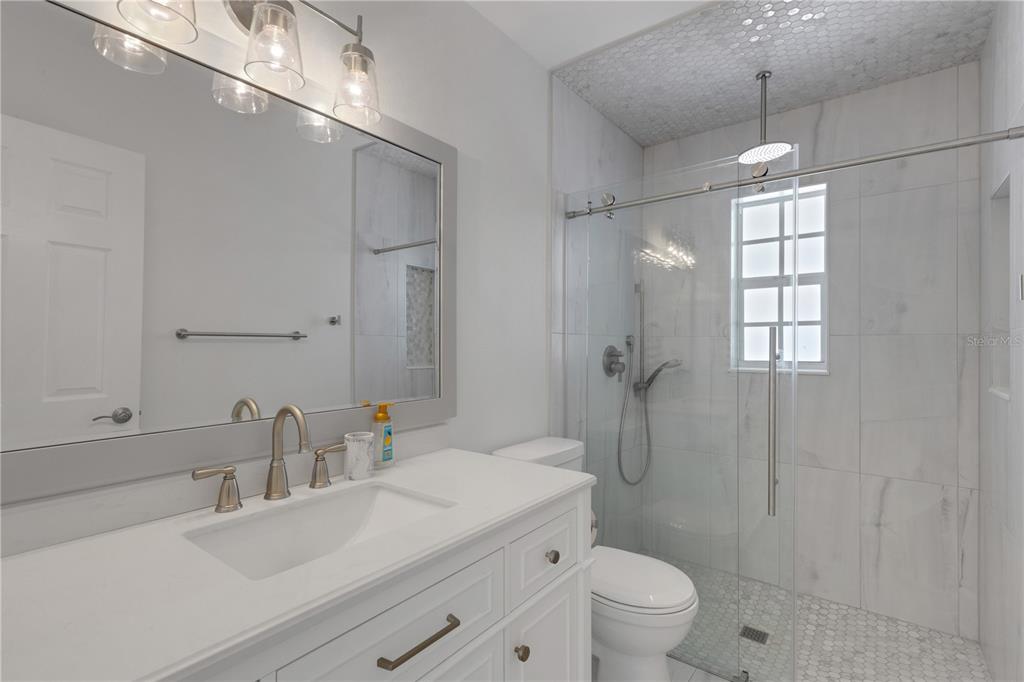 3856 Tarpon Road Venice, FL 34293 - Photo 40 of 53 a bathroom with a sink a toilet and shower