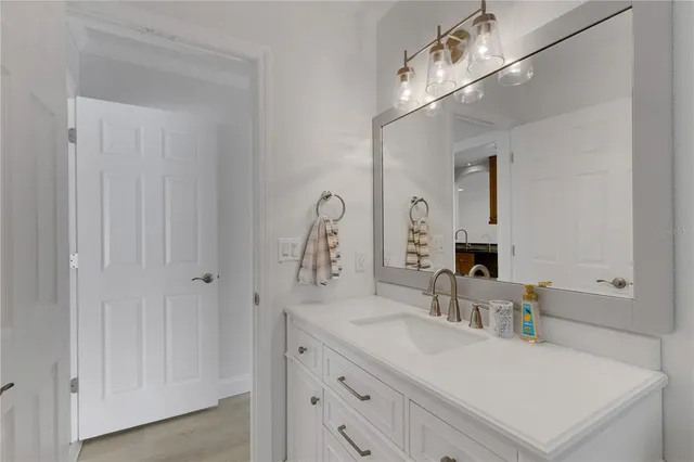 a bathroom with a sink vanity granite and a mirror