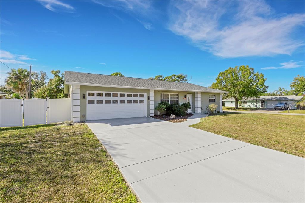 3856 Tarpon Road Venice, FL 34293 - Photo 5 of 53 a front view of a house with a yard