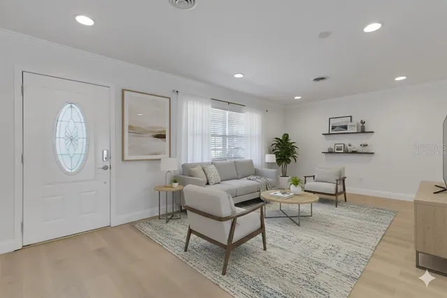 a living room with furniture a table and wooden floor