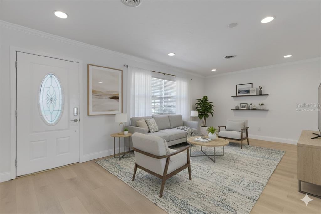 3856 Tarpon Road Venice, FL 34293 - Photo 7 of 53 a living room with furniture a table and wooden floor