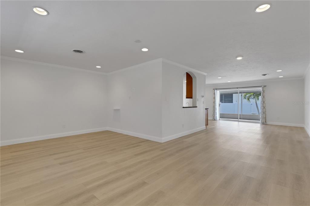 3856 Tarpon Road Venice, FL 34293 - Photo 10 of 53 a view of empty room with wooden floor and window