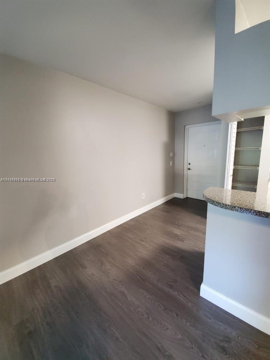 420 South Park Road, Unit 2110 Hollywood, FL 33021 - Photo 13 of 15 a view of an empty room and wooden floor