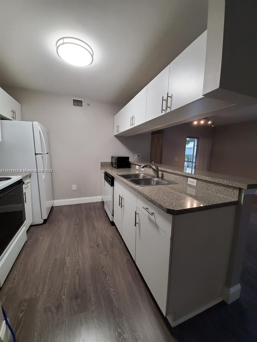420 South Park Road, Unit 2110 Hollywood, FL 33021 - Photo 15 of 15 a kitchen with stainless steel appliances granite countertop a sink and a stove top oven