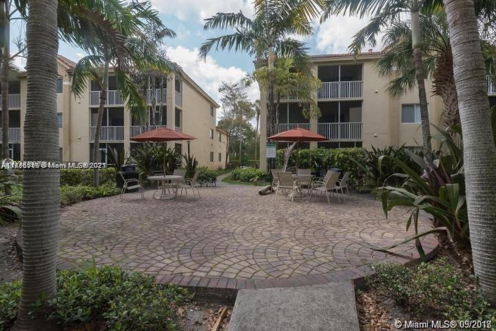 420 South Park Road, Unit 2110 Hollywood, FL 33021 - Photo 3 of 15 a view of a brick house with a yard and plants