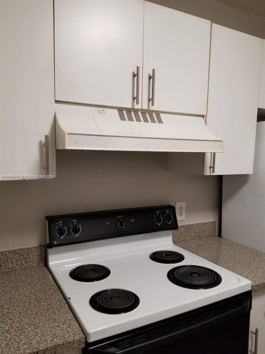 420 South Park Road, Unit 2110 Hollywood, FL 33021 - Photo 7 of 15 a kitchen with a stove and a cabinets