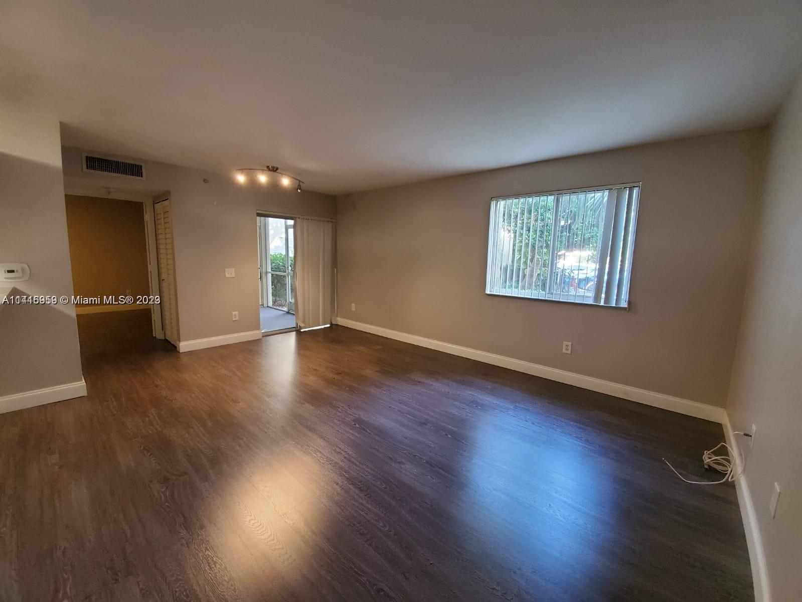 420 South Park Road, Unit 2110 Hollywood, FL 33021 - Photo 9 of 15 an empty room with wooden floor and windows