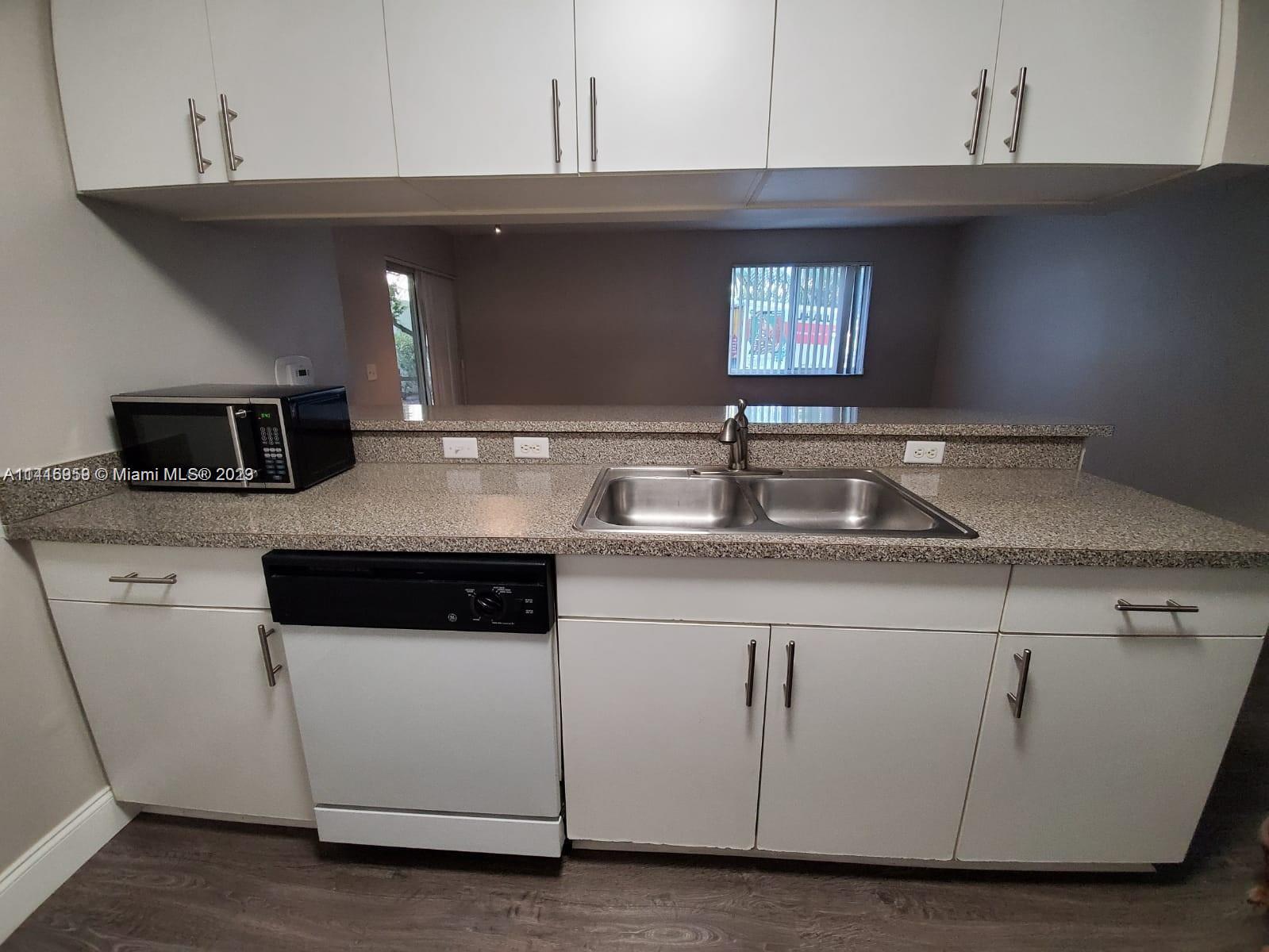 420 South Park Road, Unit 2110 Hollywood, FL 33021 - Photo 10 of 15 a kitchen with granite countertop a sink and a stove