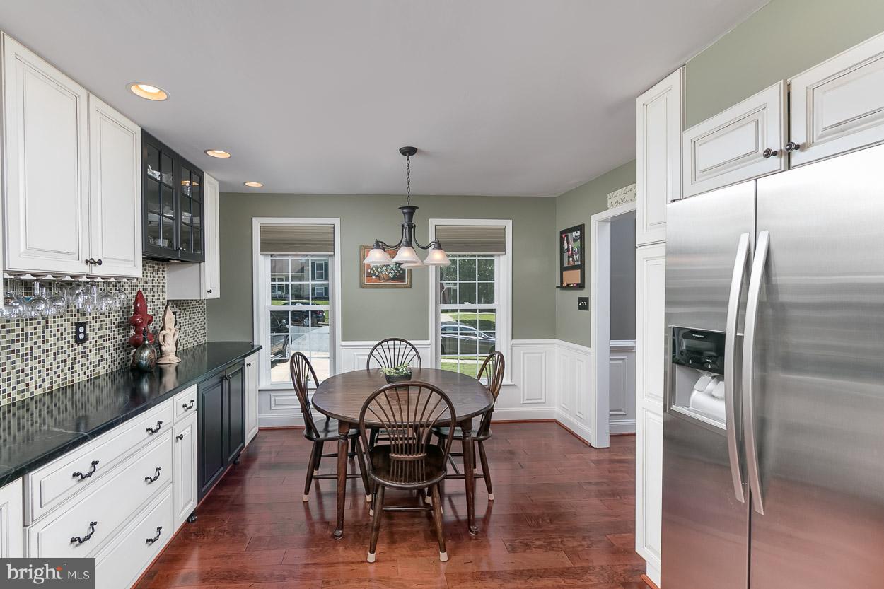 4608 Vicky Road Baltimore, MD 21236 - Photo 11 of 30 a kitchen with stainless steel appliances a dining table chairs and refrigerator
