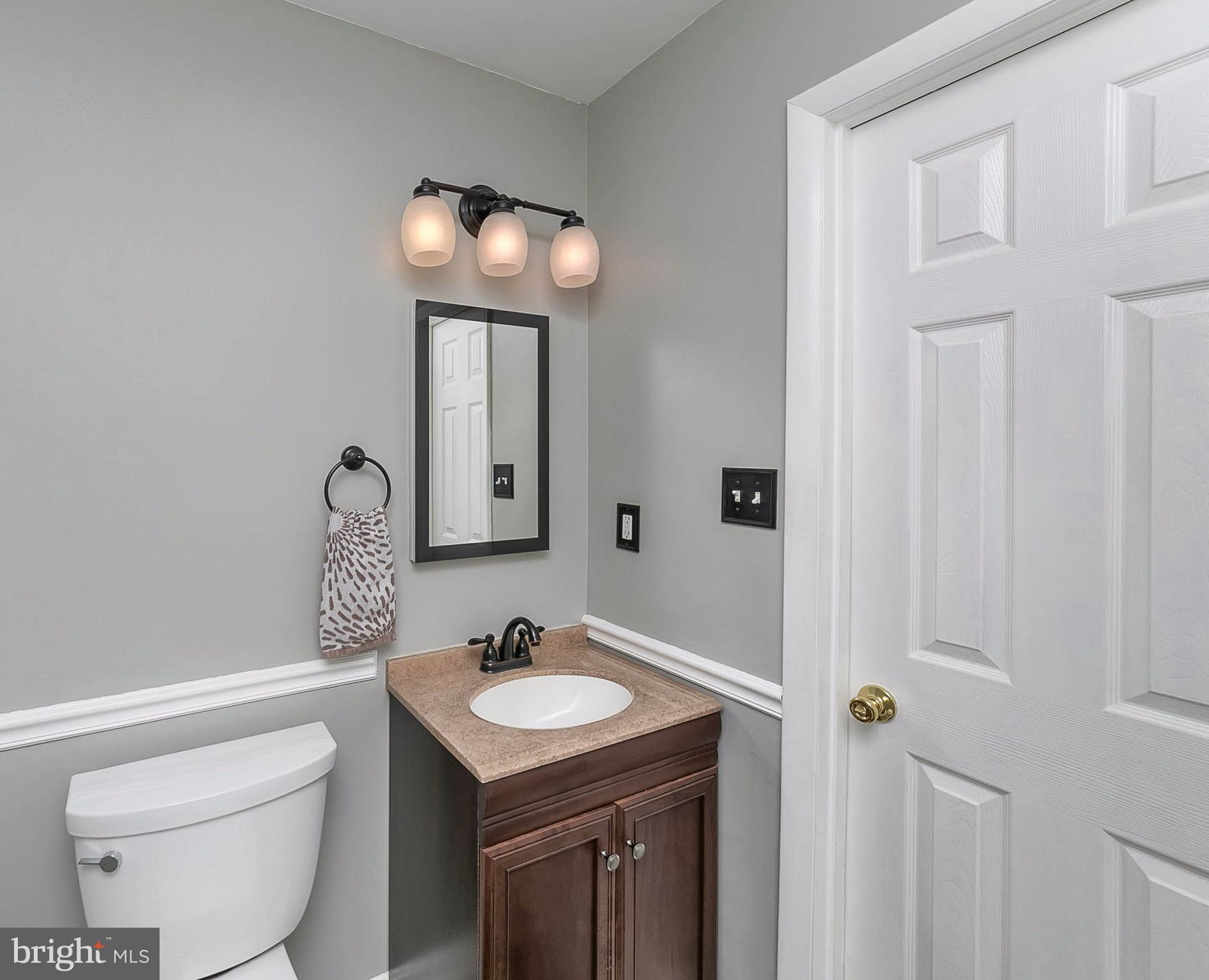 4608 Vicky Road Baltimore, MD 21236 - Photo 15 of 30 a bathroom with a sink a toilet and mirror