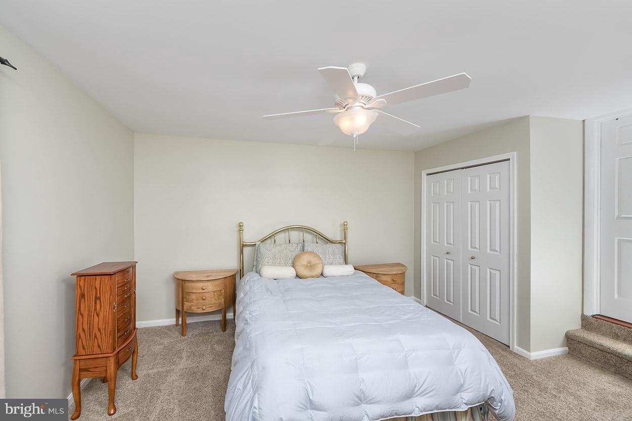4608 Vicky Road Baltimore, MD 21236 - Photo 17 of 30 a bedroom with a bed and a chandelier