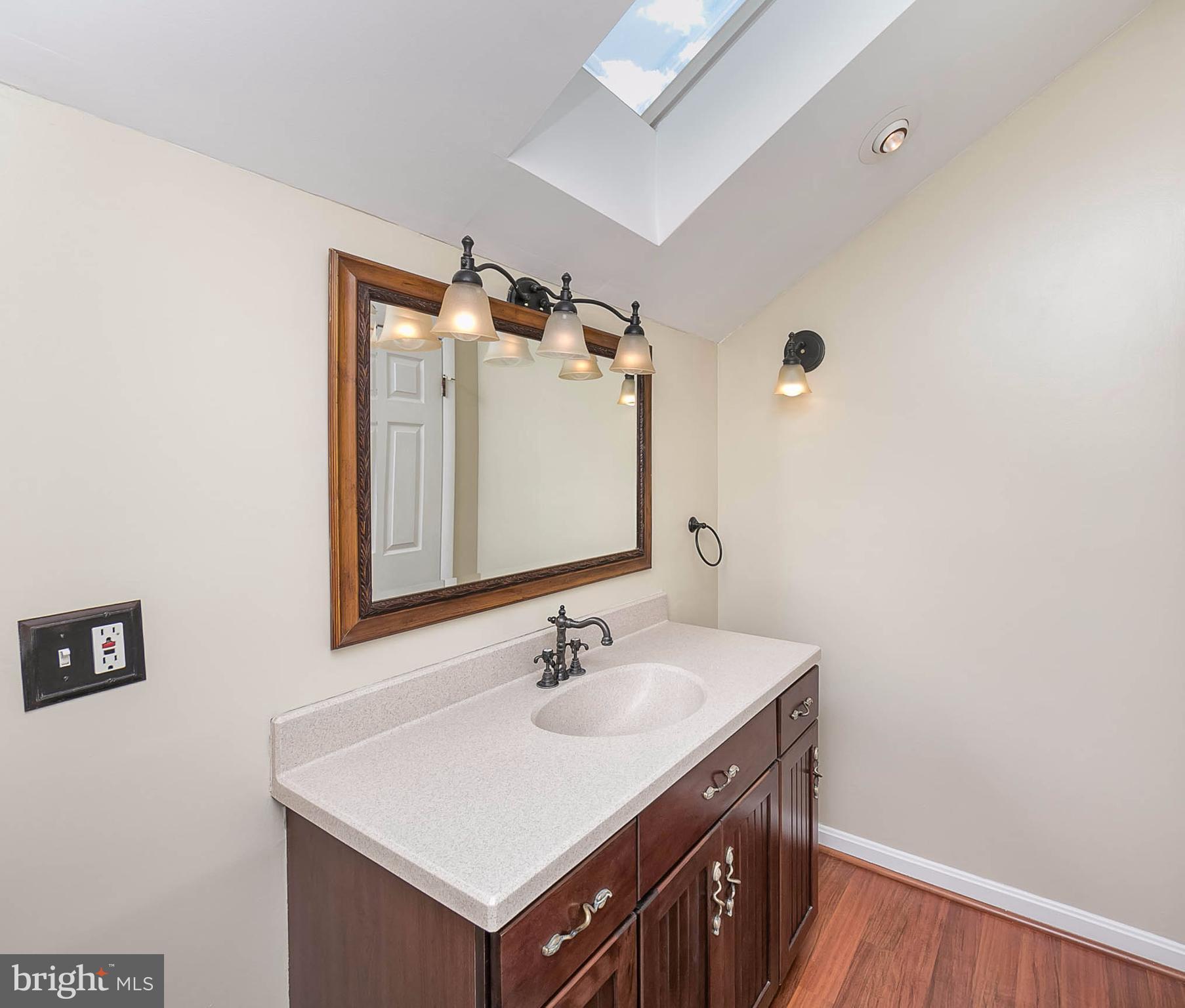 4608 Vicky Road Baltimore, MD 21236 - Photo 19 of 30 a bathroom with a sink vanity and a mirror