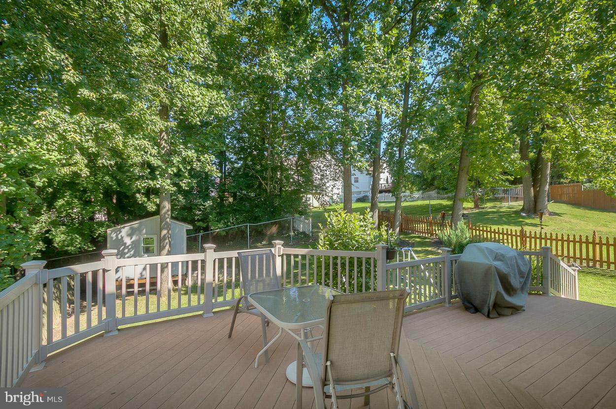 4608 Vicky Road Baltimore, MD 21236 - Photo 26 of 30 a view of a deck with two chair and wooden floor