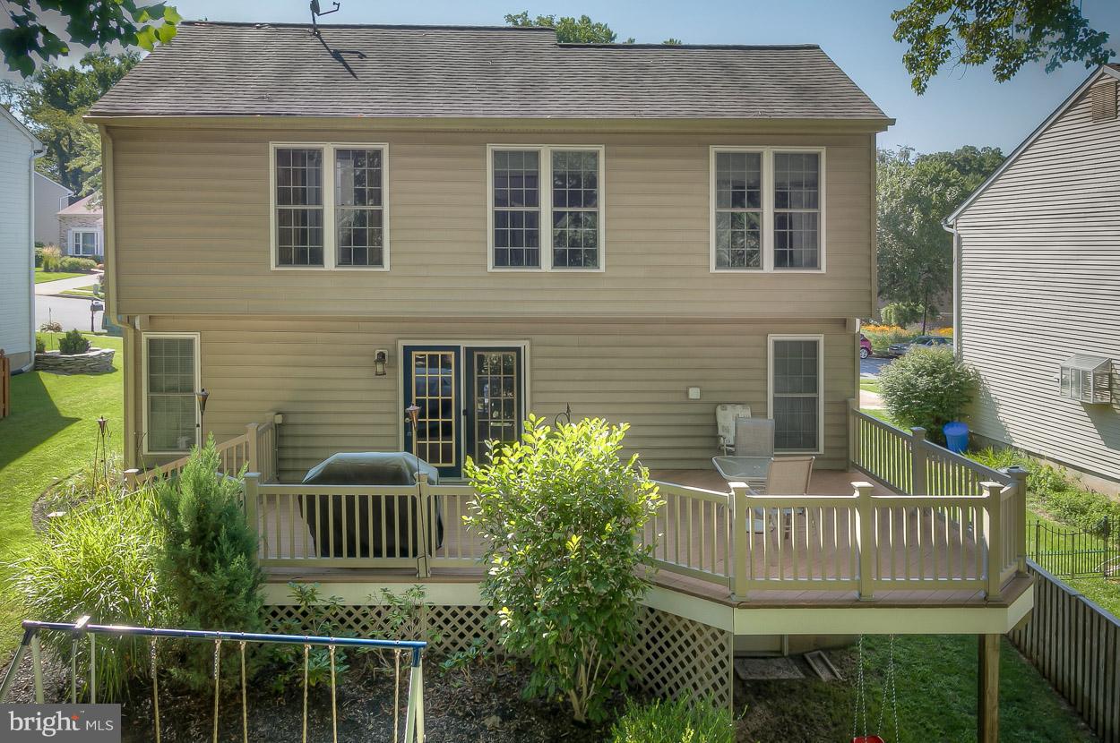 4608 Vicky Road Baltimore, MD 21236 - Photo 28 of 30 a view of a brick house with large windows and wooden fence