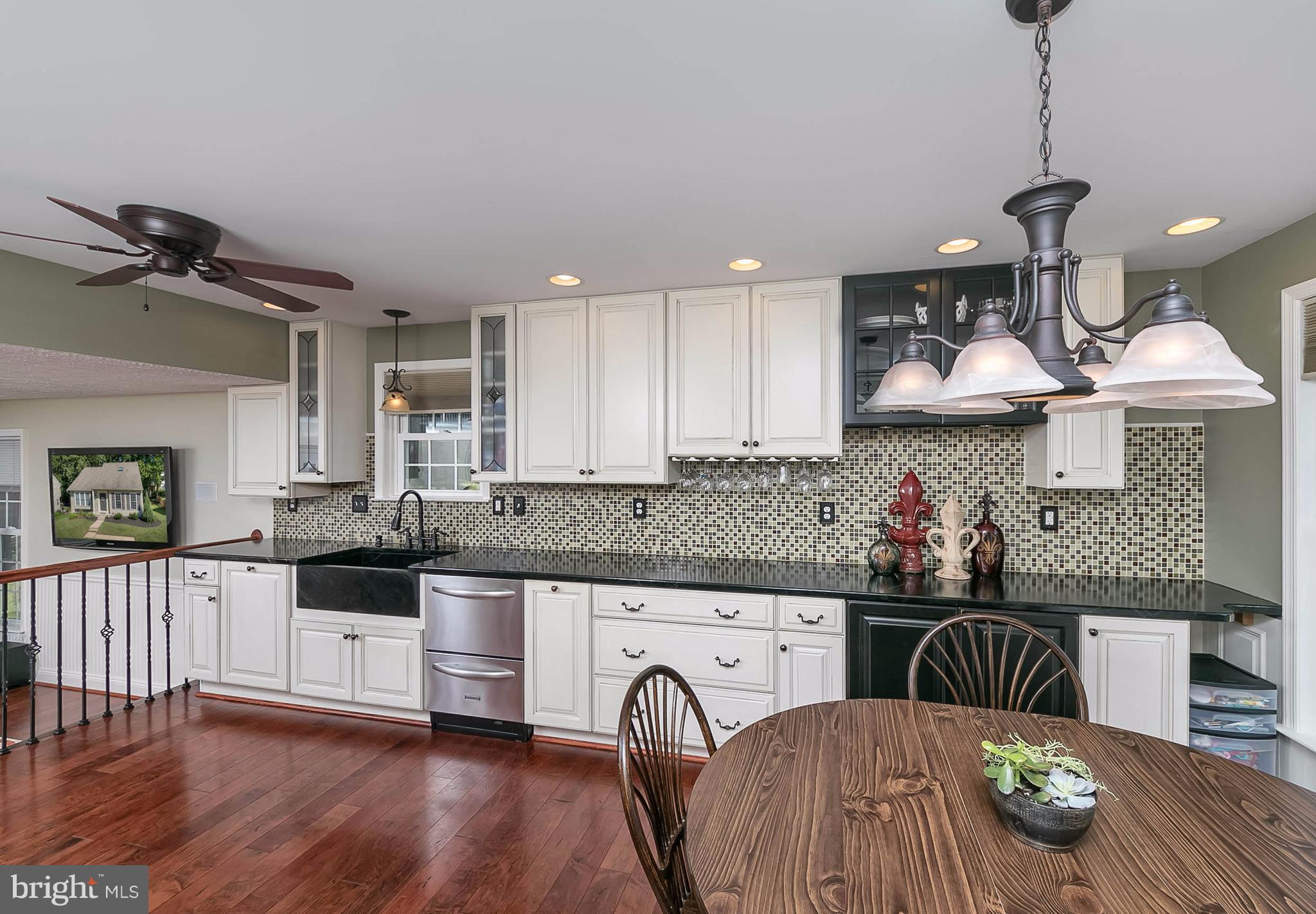 4608 Vicky Road Baltimore, MD 21236 - Photo 8 of 30 a kitchen with stainless steel appliances granite countertop a stove a sink and a wooden floors