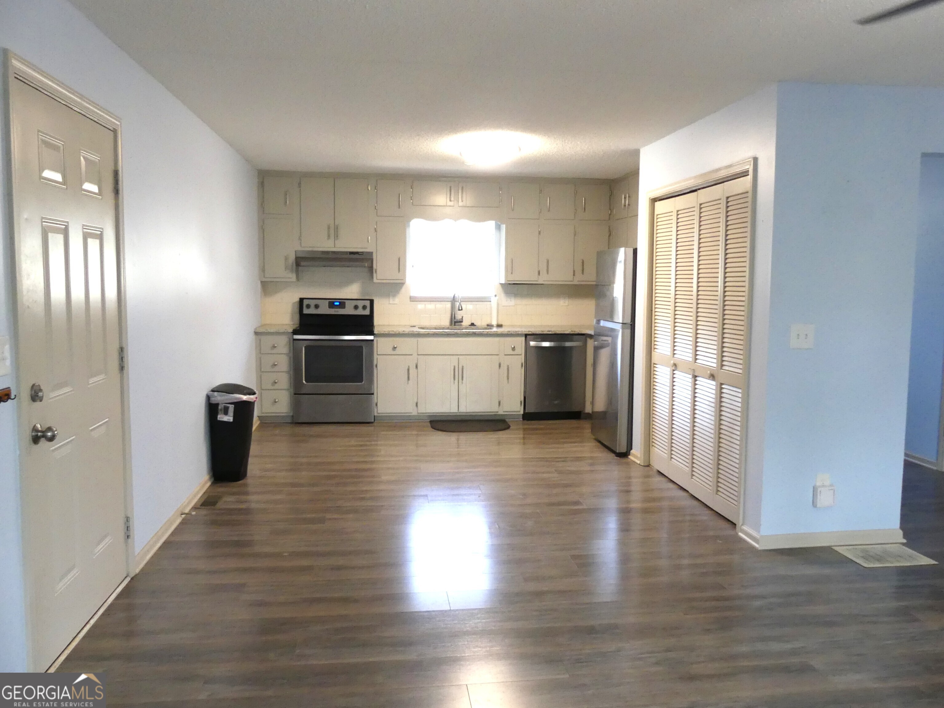 185 Stancil Drive Toccoa, GA 30577 - Photo 11 of 36 a kitchen with a wooden floor stove top oven and refrigerator