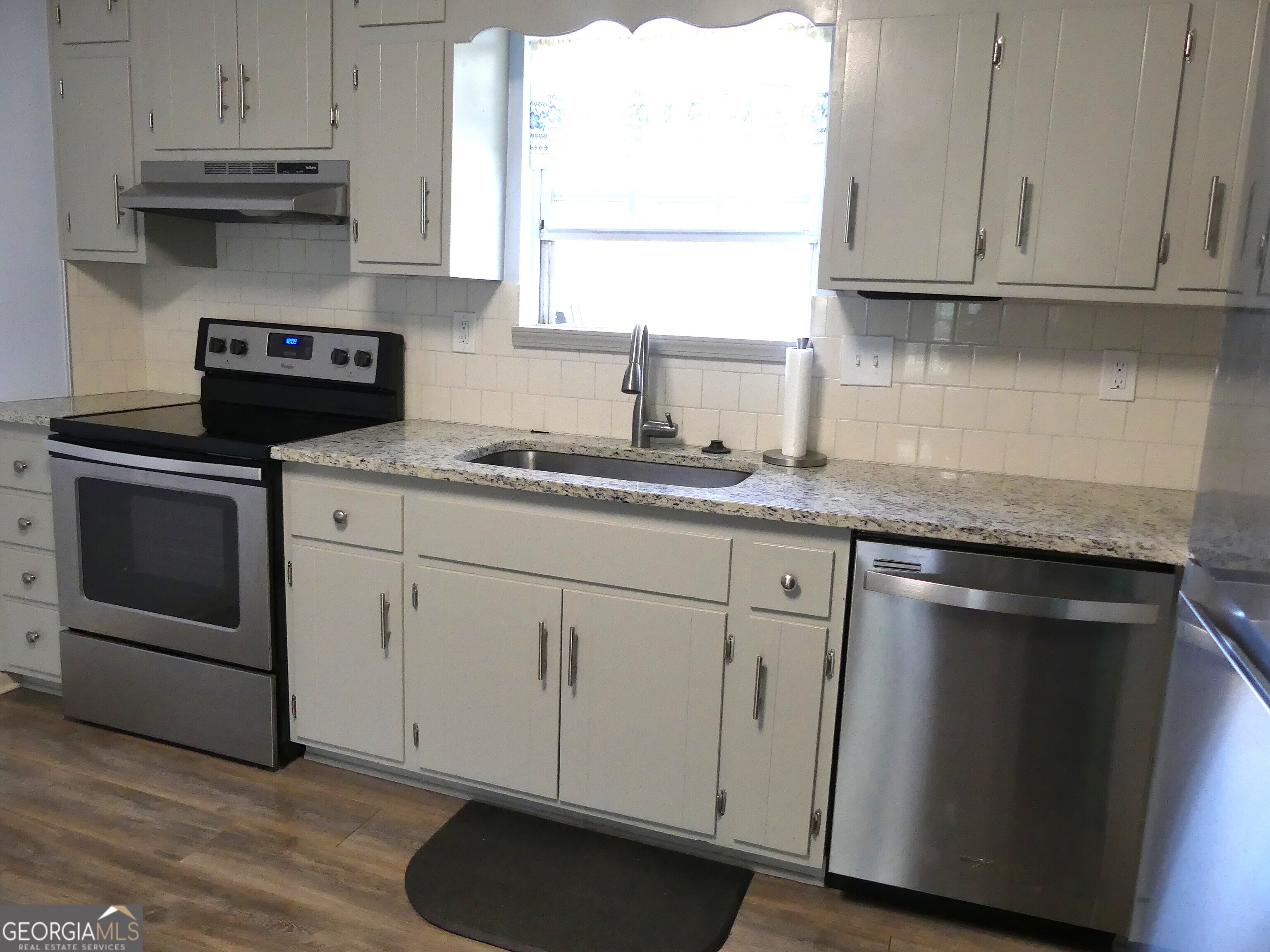 185 Stancil Drive Toccoa, GA 30577 - Photo 13 of 36 a kitchen with granite countertop white cabinets and a stove