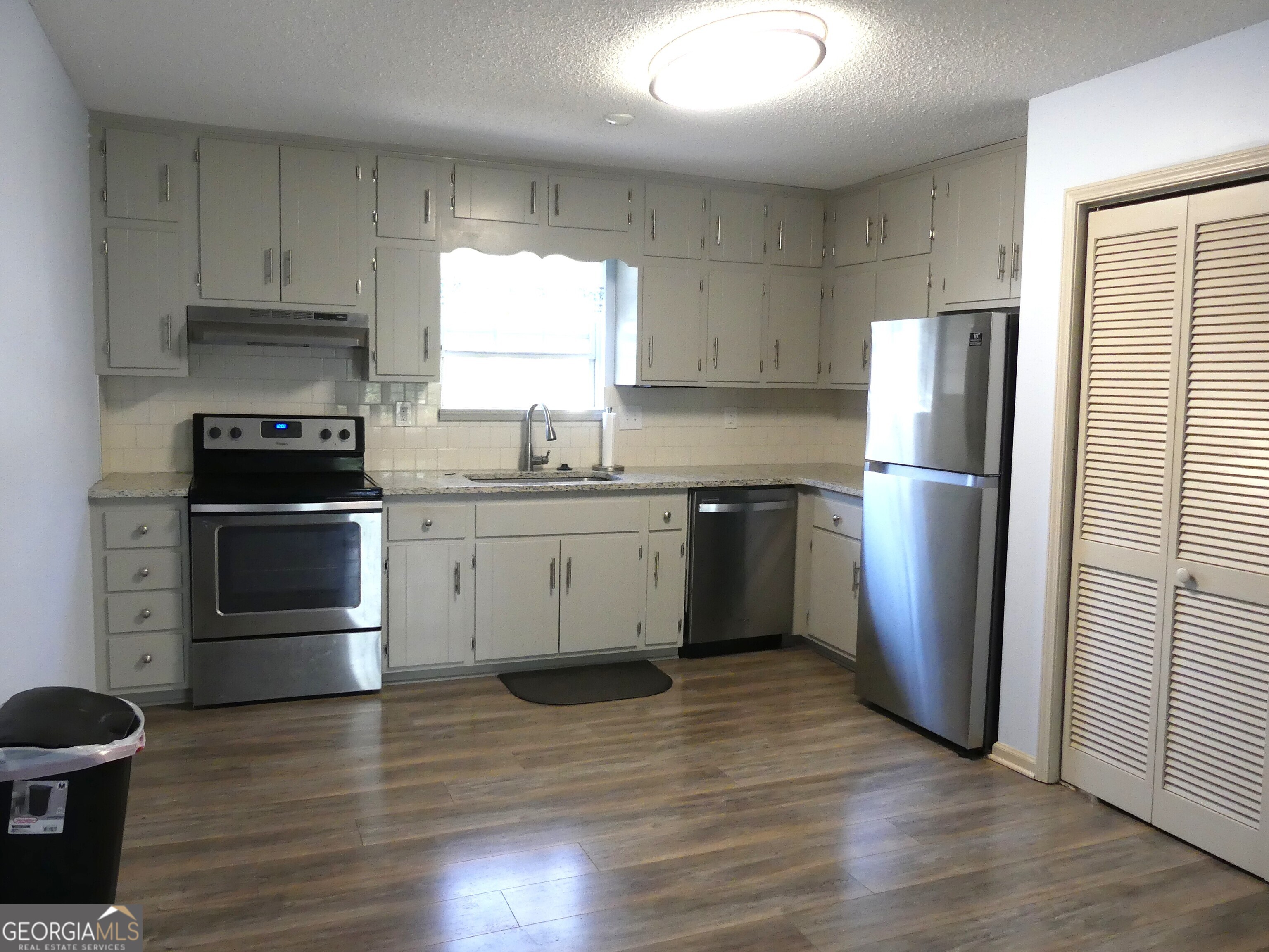 185 Stancil Drive Toccoa, GA 30577 - Photo 14 of 36 a kitchen with a refrigerator sink and wooden floor