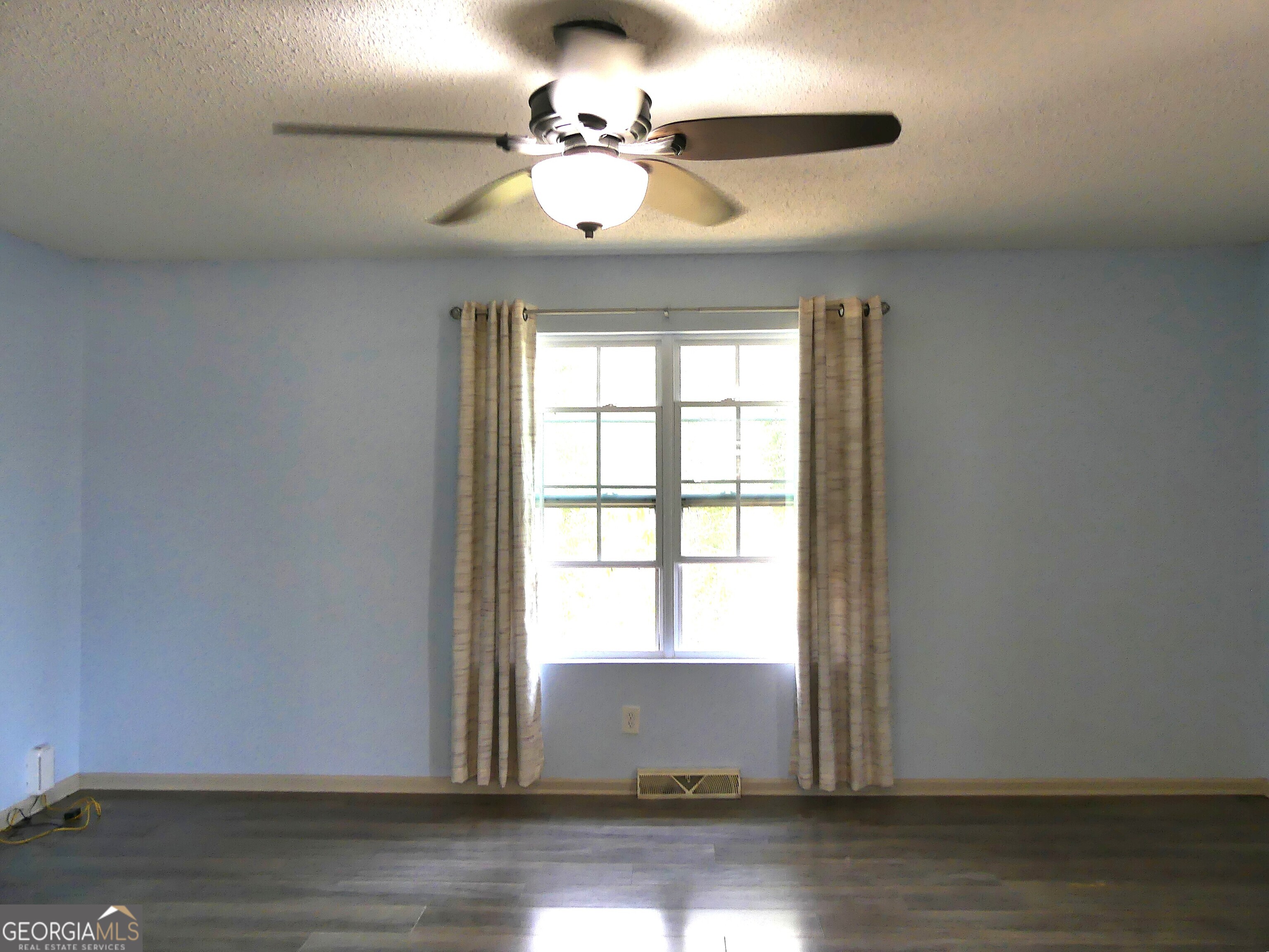 185 Stancil Drive Toccoa, GA 30577 - Photo 17 of 36 a view of an empty room with wooden floor and a window