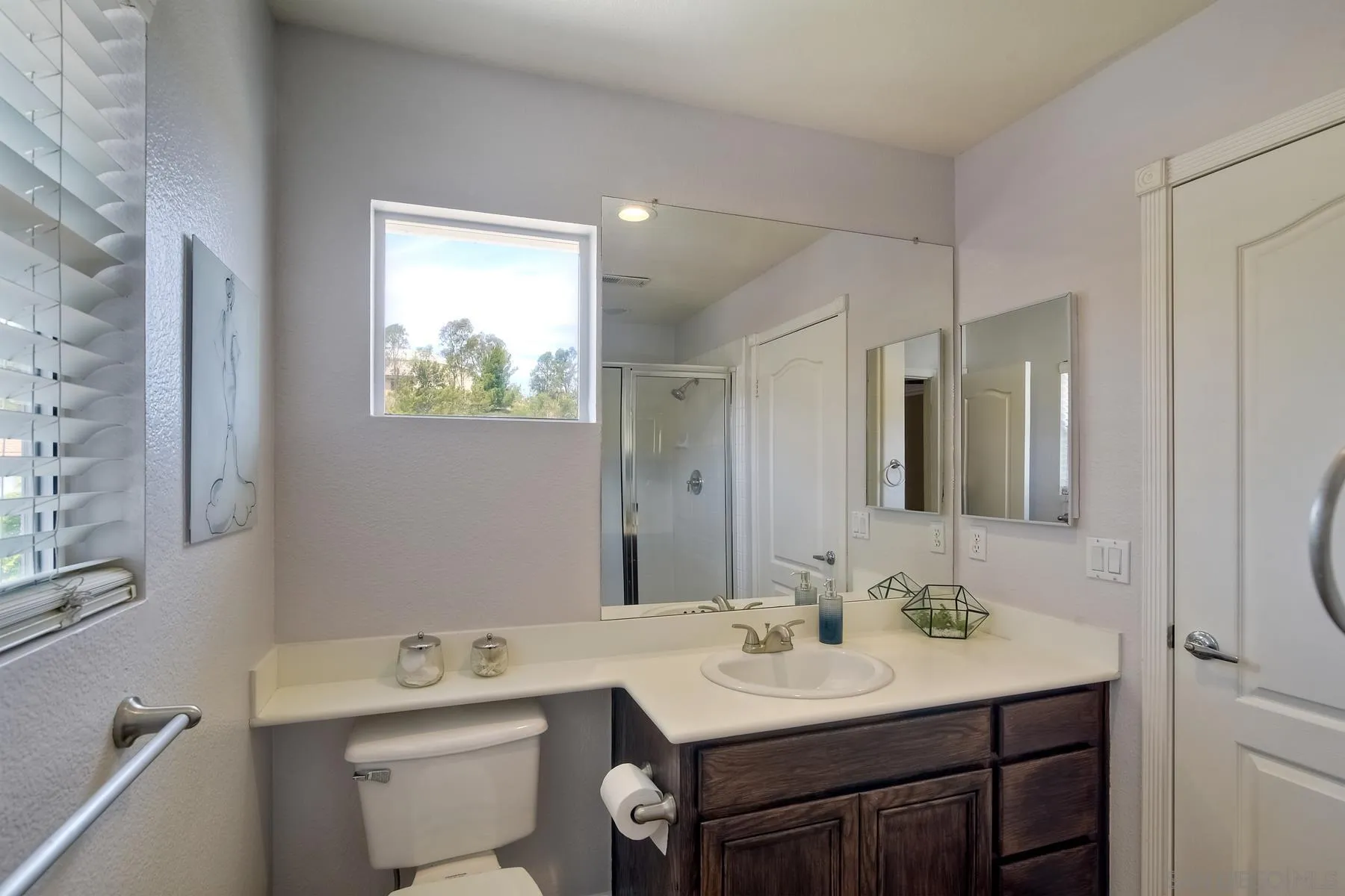 3670 Sutter Court Oceanside, CA 92056 - Photo 27 of 43 a bathroom with a sink toilet a mirror and window
