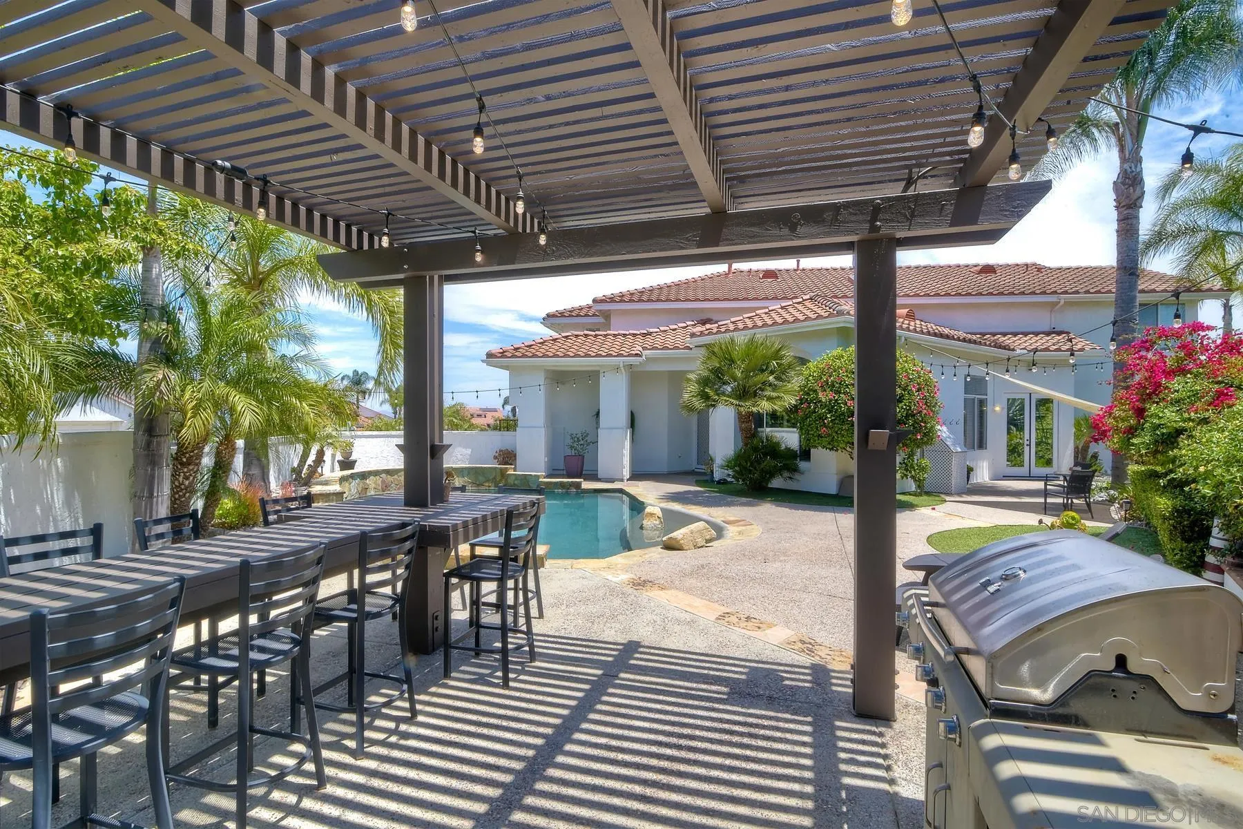 3670 Sutter Court Oceanside, CA 92056 - Photo 36 of 43 a view of a patio with table and chairs potted plants and floor to ceiling window and potted plants