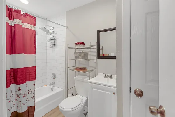 a bathroom with a sink toilet and shower