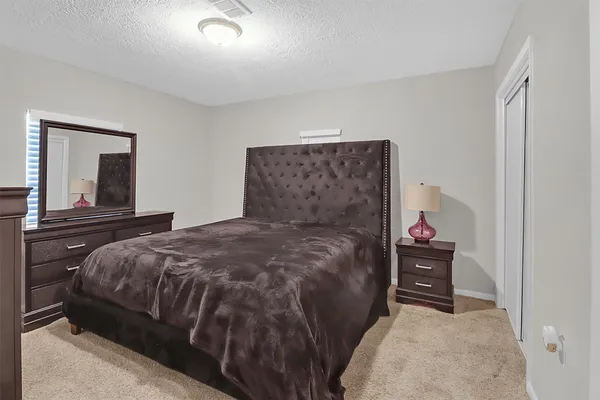 a bedroom with a bed and a cabinets