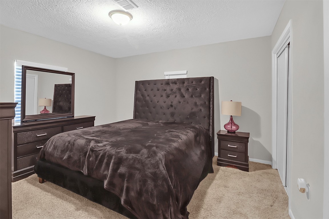 110 South 9th Street Highlands, TX 77562 - Photo 12 of 22 a bedroom with a bed and a cabinets