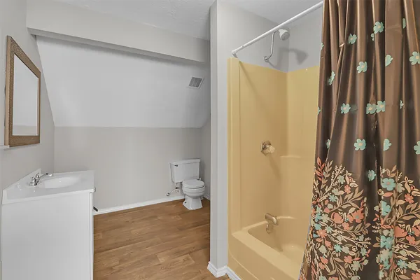 a bathroom with a shower curtain and a sink