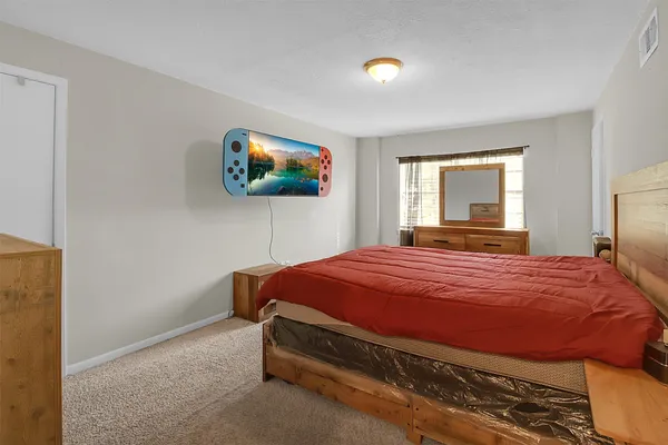 a bedroom with a bed and a flat screen tv
