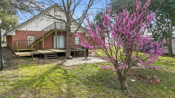 a backyard of a house with table and chairs