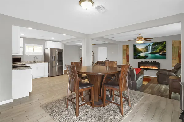 a view of a dining room with furniture and wooden floor