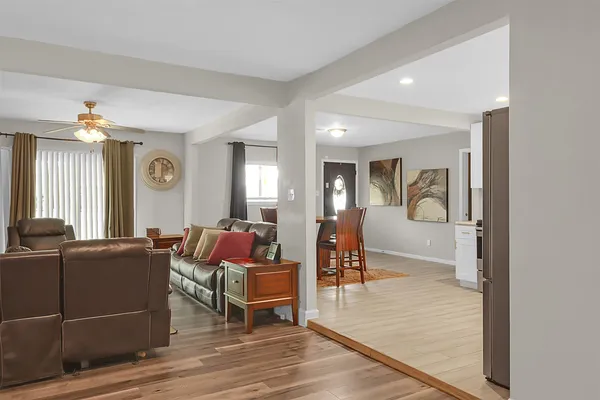 a living room with furniture and a wooden floor