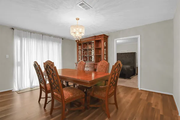 a view of a dining room with furniture window and wooden floor