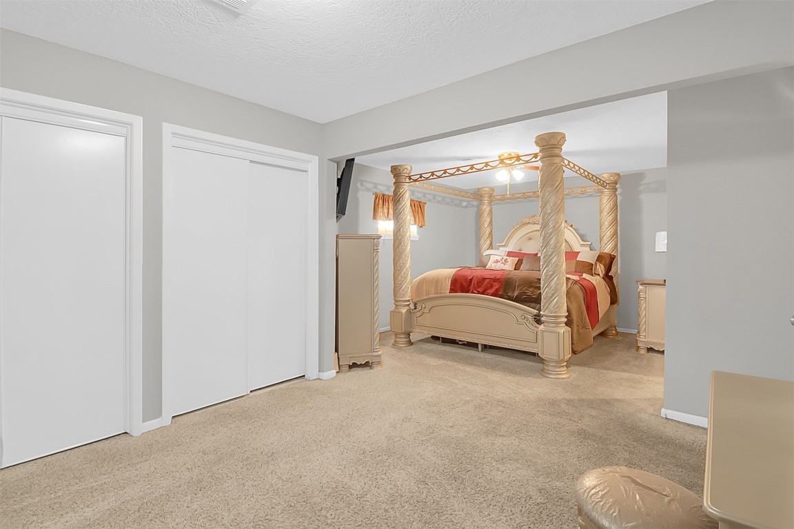 110 South 9th Street Highlands, TX 77562 - Photo 9 of 22 a bedroom with a bed and a lamp