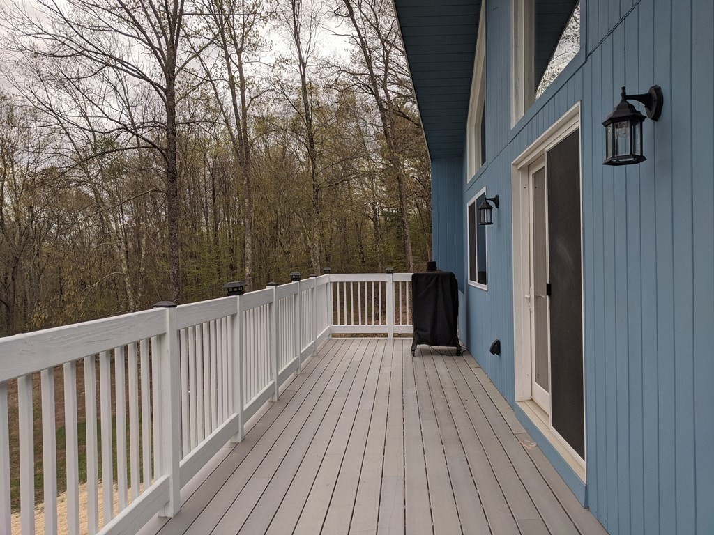 276 Old Gilbertville Road Ware, MA 01082 - Photo 4 of 42 a view of balcony with wooden floor and fence
