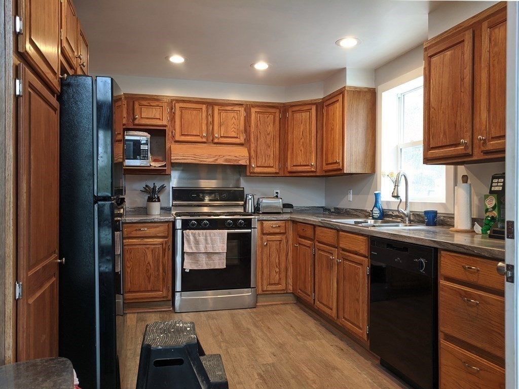 276 Old Gilbertville Road Ware, MA 01082 - Photo 5 of 42 a kitchen with stainless steel appliances granite countertop wooden cabinets a stove top oven a sink and dishwasher