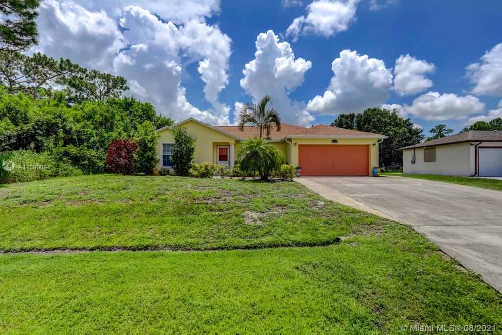 918 Southwest Longfellow Road, Unit 918 Port St. Lucie, FL 34953 - Photo 1 of 53 a view of a house with a yard