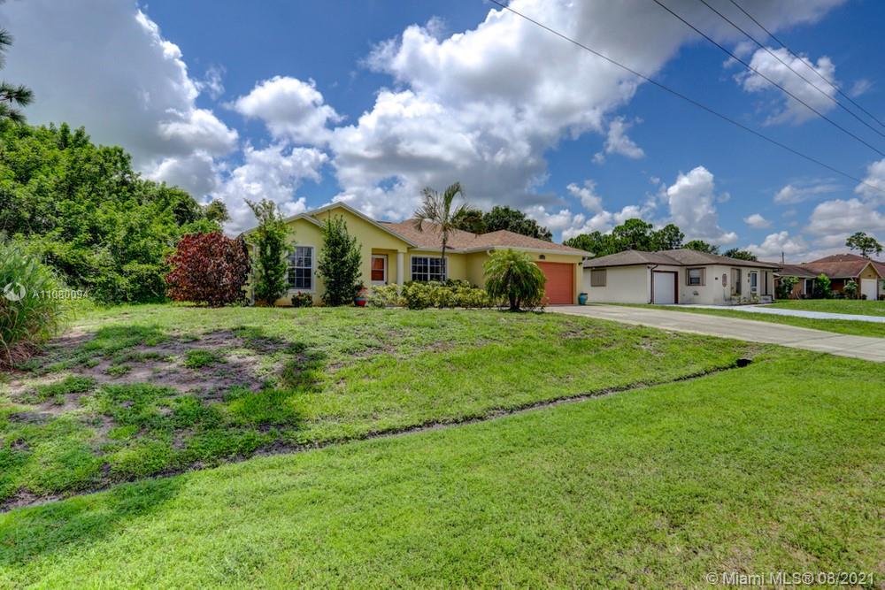 918 Southwest Longfellow Road, Unit 918 Port St. Lucie, FL 34953 - Photo 2 of 53 a view of a house with a big yard