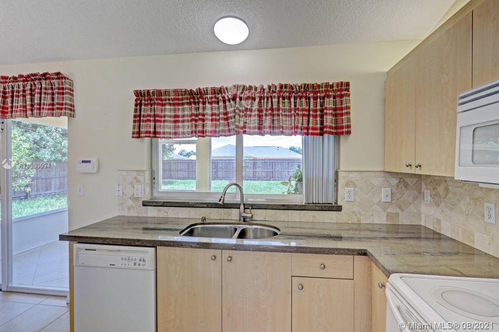 918 Southwest Longfellow Road, Unit 918 Port St. Lucie, FL 34953 - Photo 17 of 53 a kitchen with a sink and large window